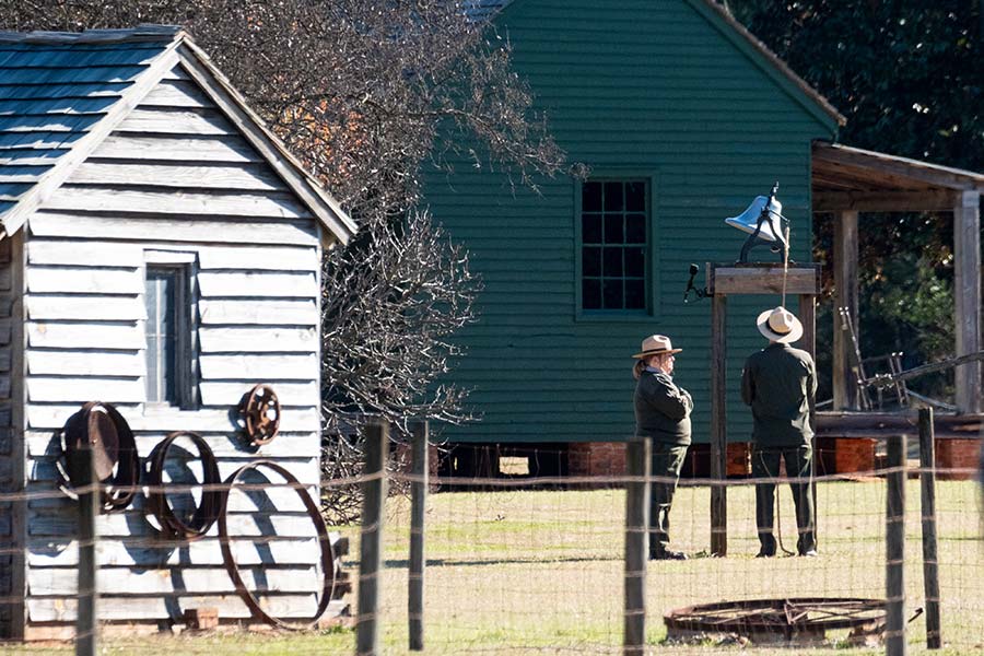 Rangers stand in front of the bell