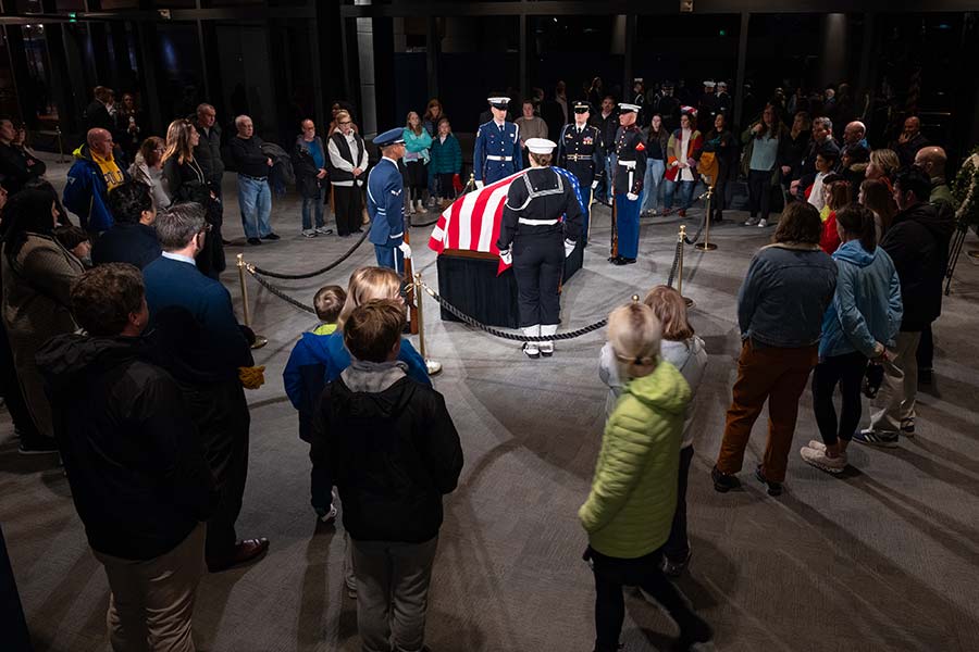 Military stands guard over the casket.